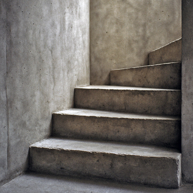 Concrete staircase demonstrating interior staircase design standards in modern architecture.
